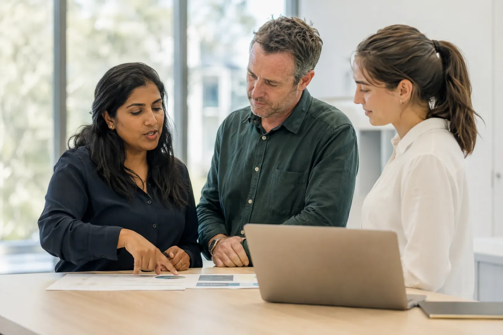 Colleagues reviewing care planning notes together at a table