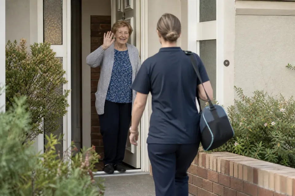 A support worker and client walking together outside a suburban home